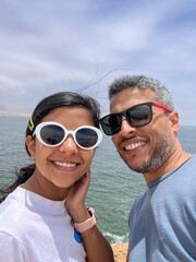 A father and daughter are smiling for a picture