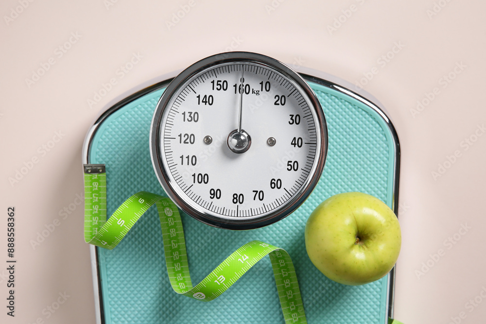 Poster Scale, measuring tape and fresh apple on beige background, top view