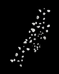 Sea salt grains in air on black background