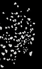 Sea salt grains in air on black background