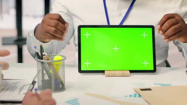 Expert shows tablet with mockup chroma key to mature couple in office, meeting for a counseling session about retirement plan options. Advisor helping senior people with their money. Camera A.