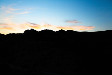 Beautiful nature landscape. Dark silhouette mount with sky.