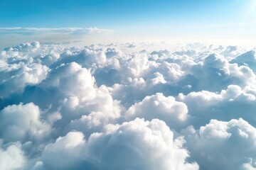 Flying over heavenly beautiful cloudscape. Picturesque panorama of dense fluffy clouds softly lit by the sun