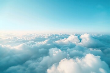 Flying over heavenly beautiful cloudscape. Picturesque panorama of dense fluffy clouds softly lit by the sun