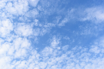 beautiful blue sky and white fluffy group of clouds with sunrise in the morning, natural background