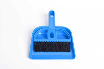 Small blue broom and dustpan set isolated on white background
