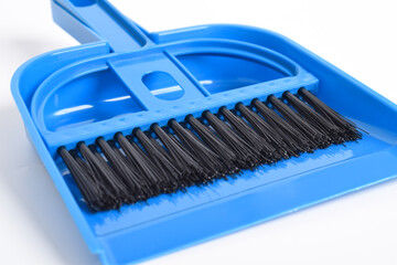 Small blue broom and dustpan set isolated on white background