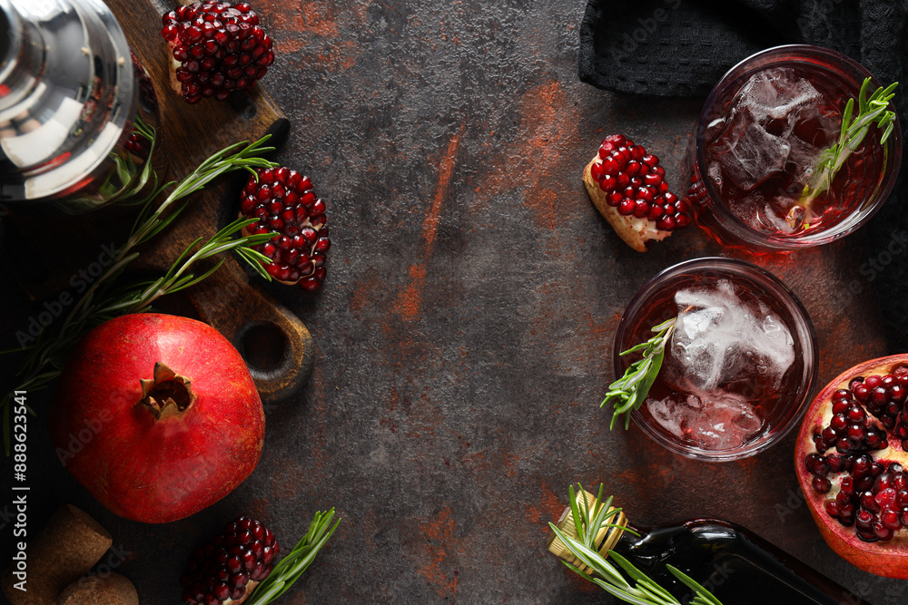 Wall mural red cocktail with fresh pomegranate on a dark background