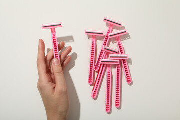 Pink razors for shaving on a white background