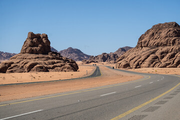 Tabuk, Saudi Arabia: The stunning red desert road near Tabuk in northwestern part of Saudi Arabia in the middle east on a sunny day