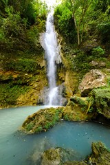 Fototapeta premium Sri Gethuk Waterfall (geological phenomenon of Bleberan) on the cliffs that flank the Oya River (Gunung Kidul Regency, Yogyakarta Special Region, Java, Indonesia)