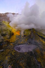 The infernal beauty of Kawah Ijen volcanic crater, known for its blue fire, labour-intensive sulfur mining and acidic crater lake (Banyuwangi and Bondowoso Regency border, East Java, Indonesia)