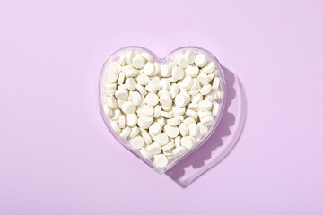 Hormonal pills for the heart, on a purple background.