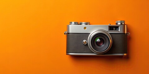 Fototapeta premium of retro camera with orange backdrop, vintage, old-fashioned, photography, equipment, technology, classic, design