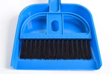 Small blue broom and dustpan set isolated on white background