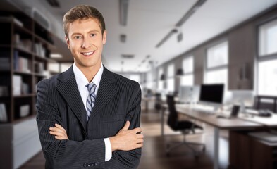 Fototapeta premium Happy confident business man standing in office