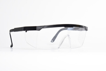 Clear plastic safety goggles isolated on white background