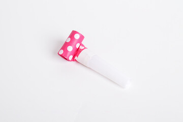 Rolled festive noisemaker or party whistle horn on the white isolated on white background