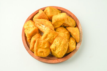 Tahu Takwa is tofu that has a yellow color by soaking tofu in turmeric water. Fried yellow tofu is a specialty food from Kediri, East Java, Indonesia. Concept for Plant based protein - Flat Lay Photo
