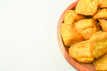 Tahu Takwa is tofu that has a yellow color by soaking tofu in turmeric water. Fried yellow tofu is a specialty food from Kediri, East Java, Indonesia. Concept for Plant based protein - Flat Lay Photo