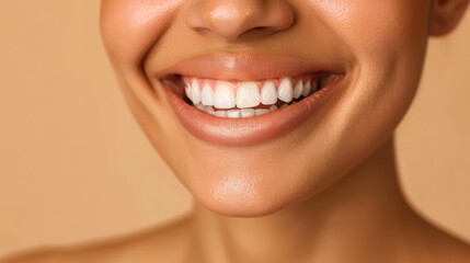 Obraz premium Close up portrait of beautiful woman smiling with white teeth and healthy lips on beige background.