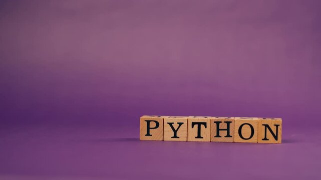 purple warm background with shadows wooden cubes with black letters and laid out words from letters python