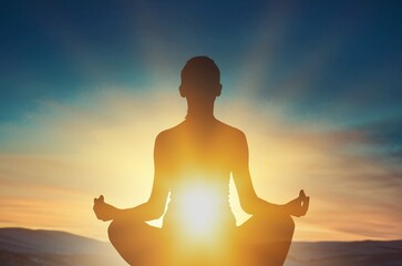 Woman young person in yoga pose meditation at sunset.