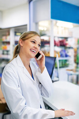 Woman, pharmacy and phone call with internet for medical job or healthcare, discussion for medicine or stock. Female pharmacist, drug store and working with mobile for telehealth at point of sale