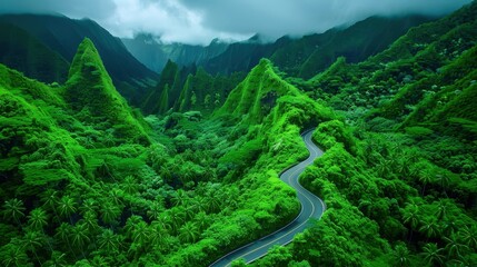 Scenic winding road through lush green mountains under a cloudy sky, showcasing breathtaking natural beauty and serene landscape.