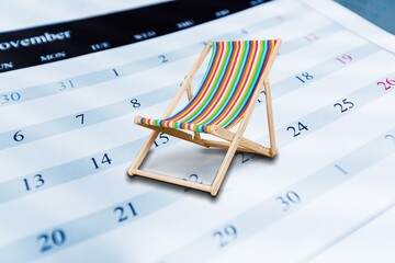 Beach chair on blank calendar at worker desk