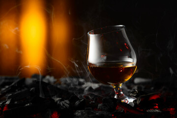 Snifter of brandy on a burning charcoal.