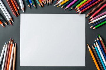 colored pencils and blank paper on wooden table