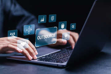 Outsourcing concept, Human resources and global recruitment for business. Businessman using computer laptop with outsourcing icons on virtual screen.