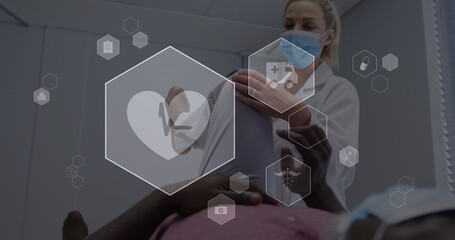 Image of digital icons data processing over caucasian female doctor in face mask