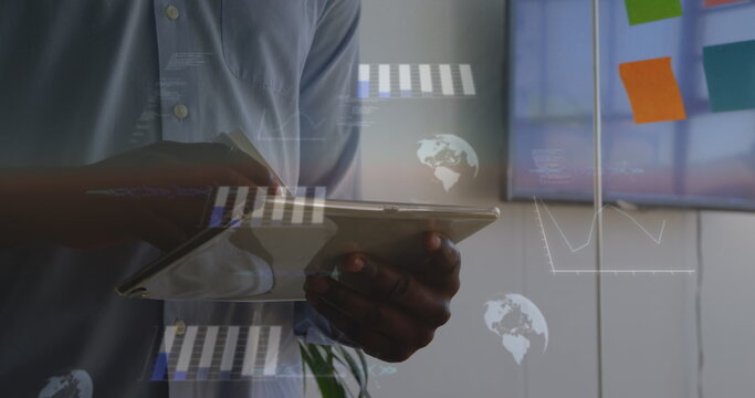 Image of statistical data processing against mid section of a man using tablet at office - Powered by Adobe