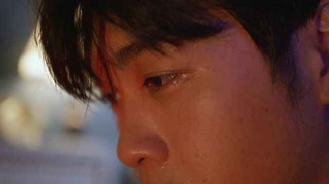 portrait close up of asiatic male man crying with tears falling from his eyes on sorrow and pain
