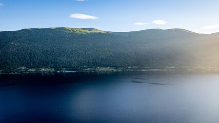 drone aerial view over Andalsnes and Romsdalseggen mountains in summer with sunset and fog in Norway Romsdalen and Romsdalseggen Ridge
