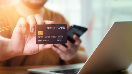 Man Using Smartphone Shopping Online Holding Credit Card Making Payment At Home. Mobile payment with wallet app technology. Internet Banking Application And E-Commerce, Digital money transfer