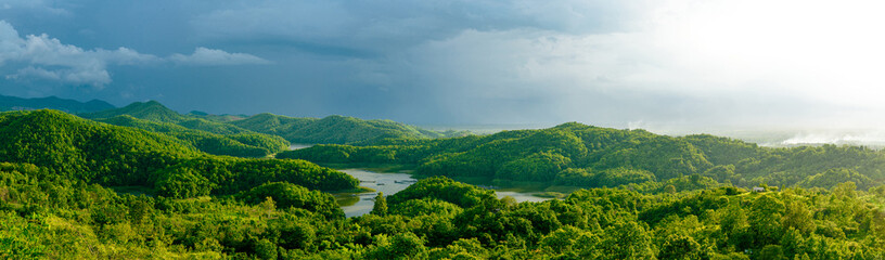 Panorama view from top of the mountain in countryside with lake and big tree of tropical rainforest and sunlight at afternoon. Wonderful springtime landscape in mountains.