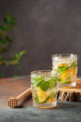 Lemonade or mojito cocktail with lemon and mint, cold refreshing drink or beverage with ice
