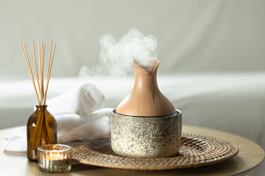 Aroma oil diffuser lamp with the sticks perfume and candle.