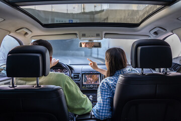 Man and woman traveling in car, sitting in car driving to travel destination.