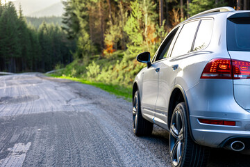 Car on the road in a forest in a mountainous area, the concept of a road trip.