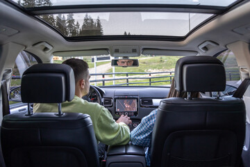 Man and woman traveling in car, sitting in car driving to travel destination.