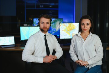 Center of dispatching maintenance. Portrait of cheerful woman and man working via headset...