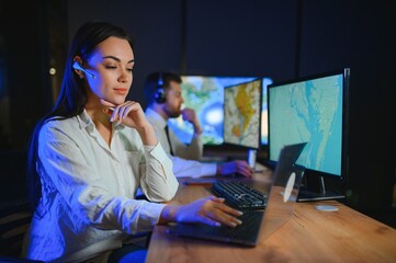 Center of dispatching maintenance. Portrait of cheerful woman and man working via headset...