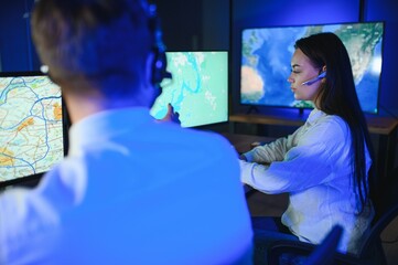 Center of dispatching maintenance. Portrait of cheerful woman and man working via headset...