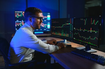 Financial Analysts and Day Traders Working on a Computers with Multi-Monitor