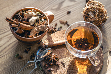 Fragrant hot tea with cinnamon on a wooden table, top view.