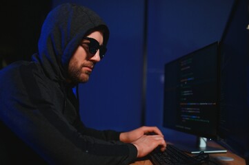 Programmer or computer hacker typing code
